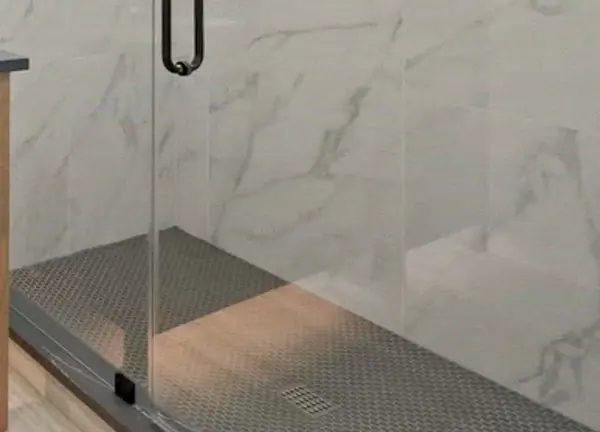 Frameless glass shower door over marble-look porcelain tile